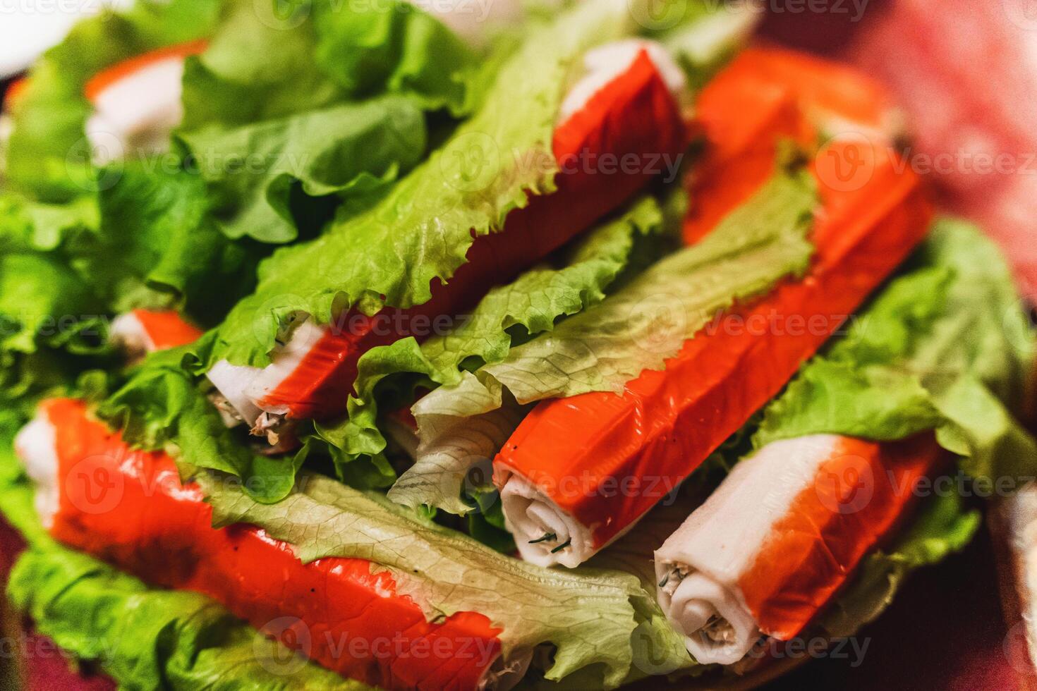 delizioso Granchio bastoni ripieno con pesce, erbe aromatiche, e salsa su un' piatto con verde foto