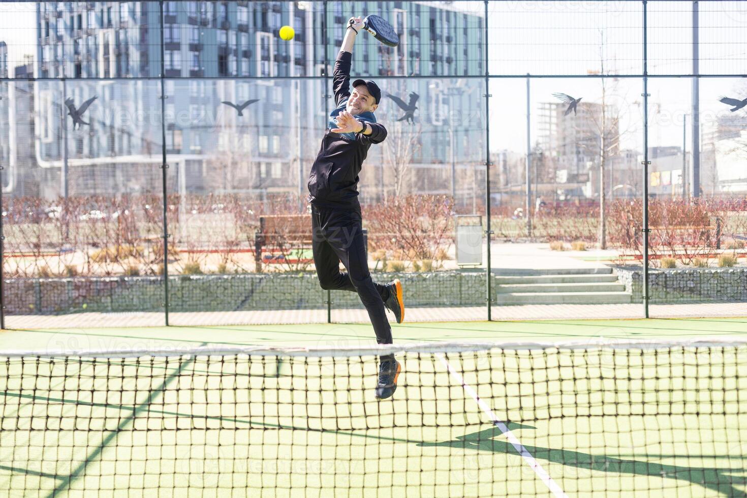 uomo giocando pagaia tennis. salto e tiro il sfera. foto