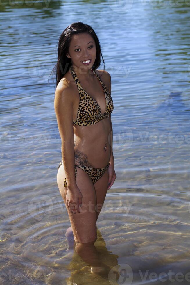 giovane asiatico americano donna bikini fiume sorridente foto