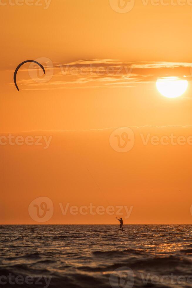 kiteboarding kitesurf kiteboarder kitesurfer aquiloni silhouette nel il oceano su tramonto foto