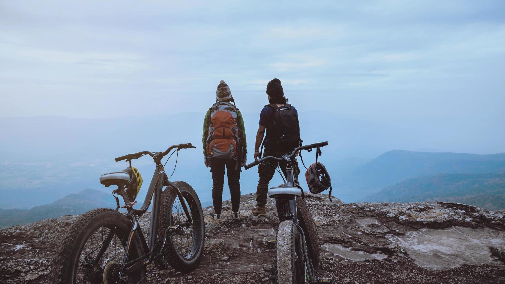 donne e uomini amante asiatici viaggiano nella natura. viaggio relax andare in bicicletta natura selvaggia. in piedi su una scogliera rocciosa. Tailandia foto