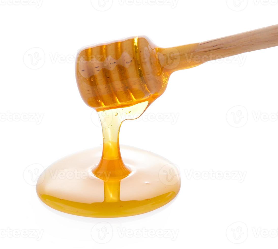 mestolo di miele in legno con miele foto