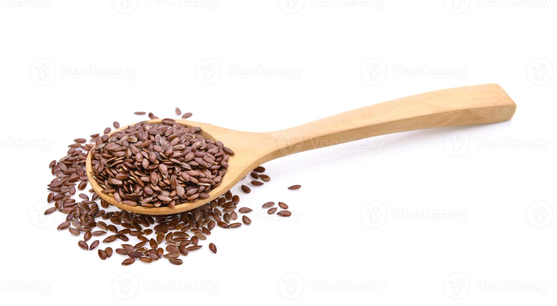 semi di lino in cucchiaio di legno su sfondo bianco foto