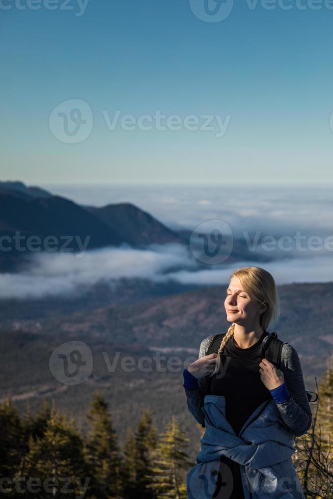 donna che si gode l'aria fresca di montagna mentre fa un'escursione alla vetta del richardson foto