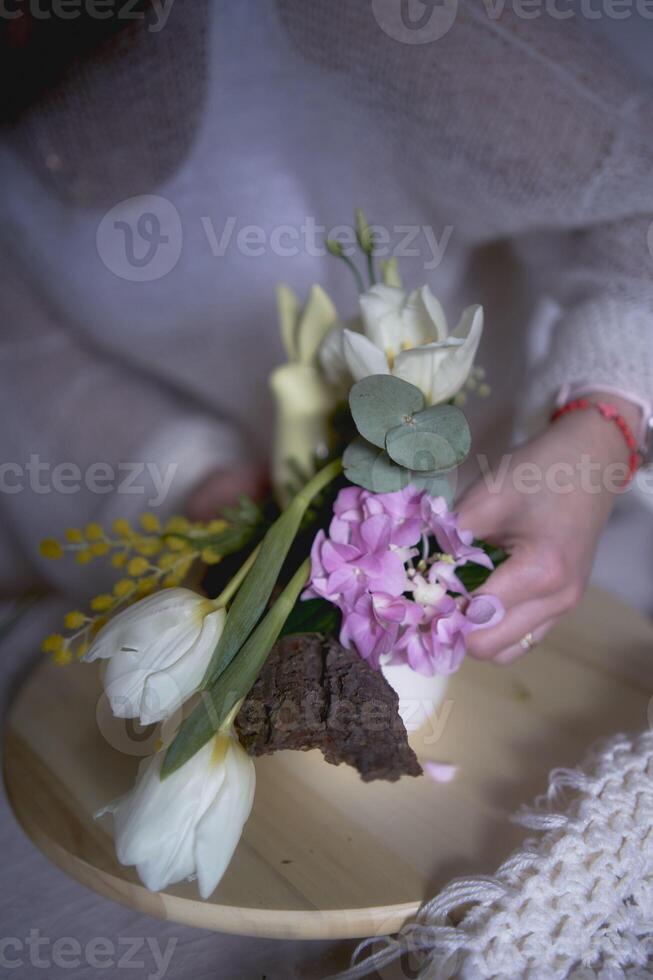 femmina fioraio rendere decorazioni e floreale accordi per Pasqua foto