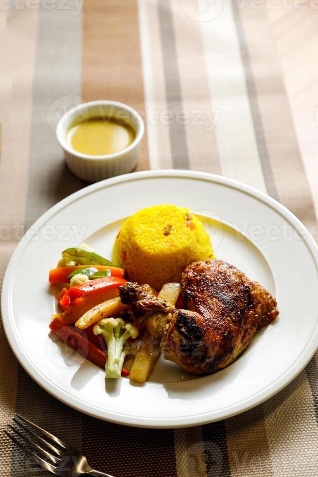 arrostito pollo con erba riso con insalata, immersione, cucchiaio e forchetta servito su piatto isolato su tovagliolo lato Visualizza di veloce cibo su tavolo foto