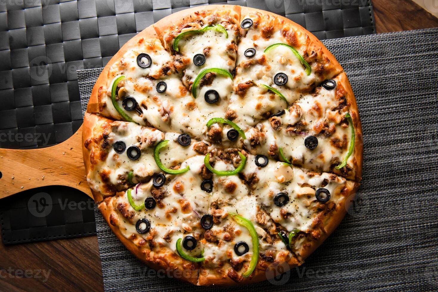 quattro stagione Pizza guarnizione con oliva e verdure isolato su di legno tavola superiore Visualizza di Fast food foto