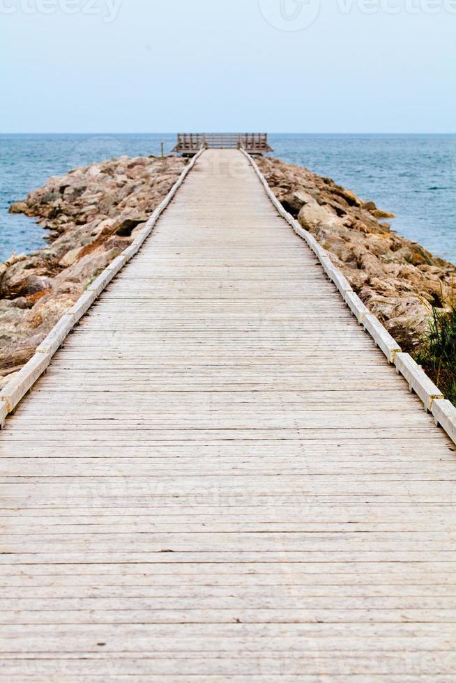 lungo pontile in legno con osservatorio e vista sull'oceano foto