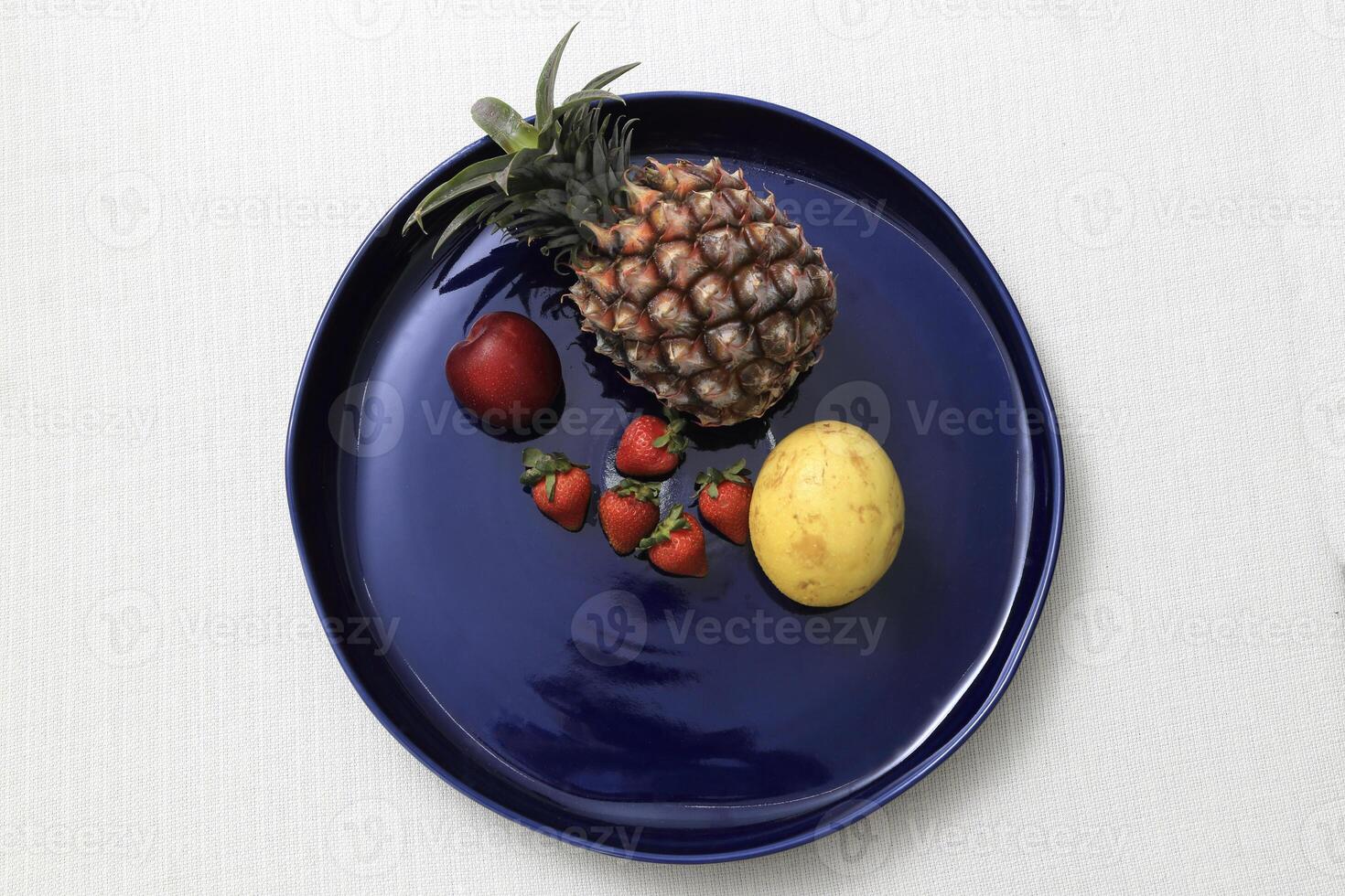 blu ceramica piatto con parecchi diverso frutta foto