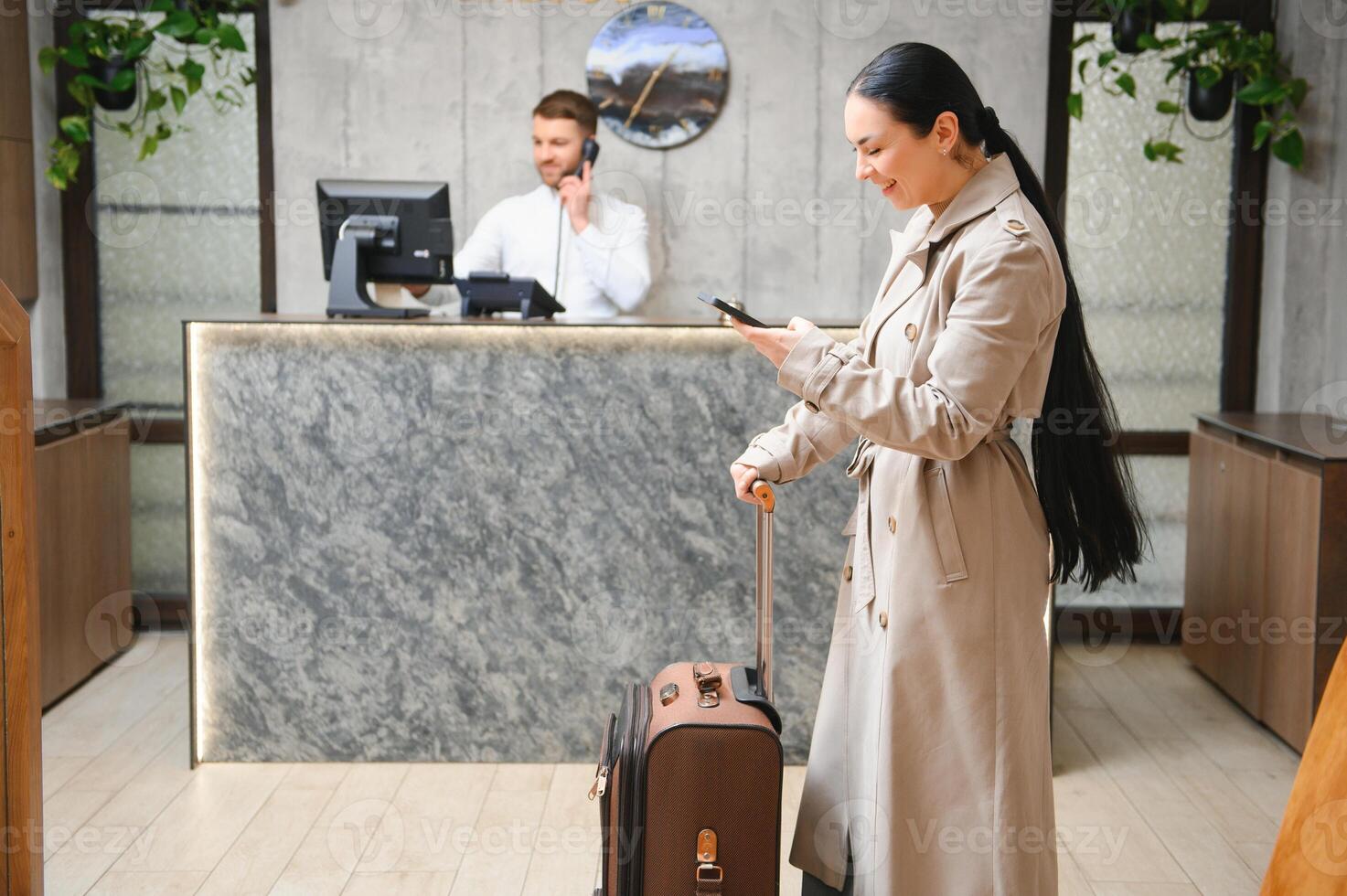 donna d'affari con bagaglio nel moderno Hotel atrio foto