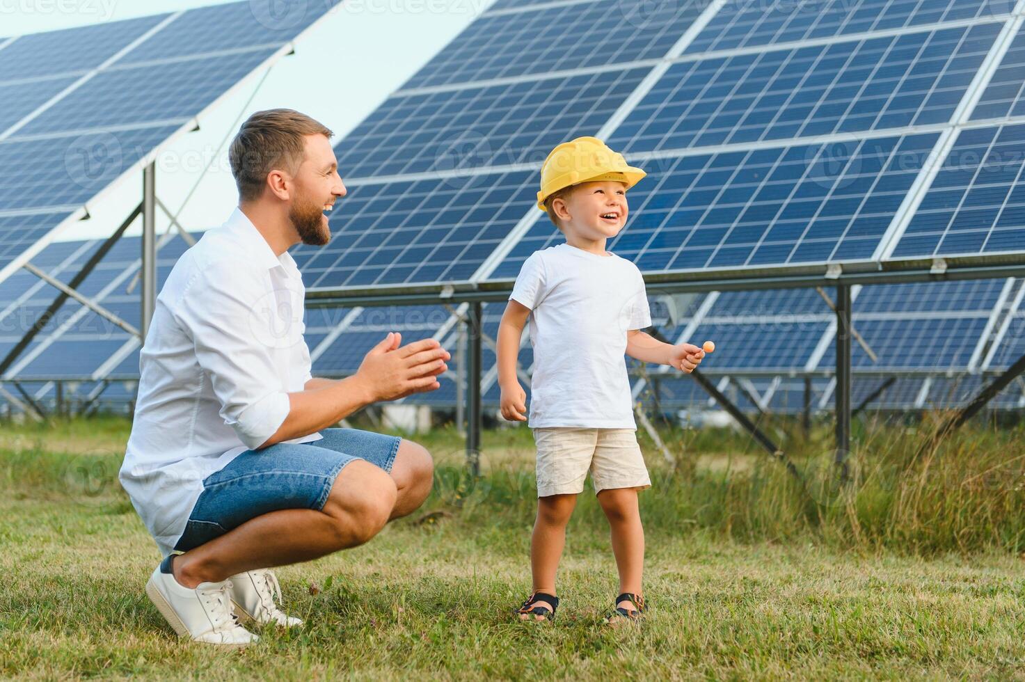 contento padre e il suo poco figlio siamo a piedi vicino il solare pannelli. il concetto di verde energia. foto