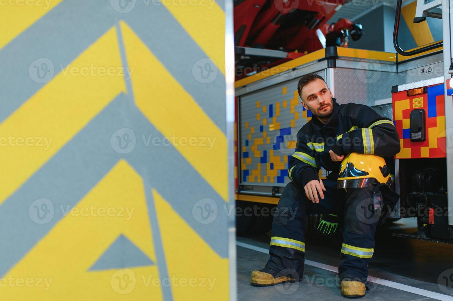 foto di giovane vigile del fuoco vicino fuoco motore