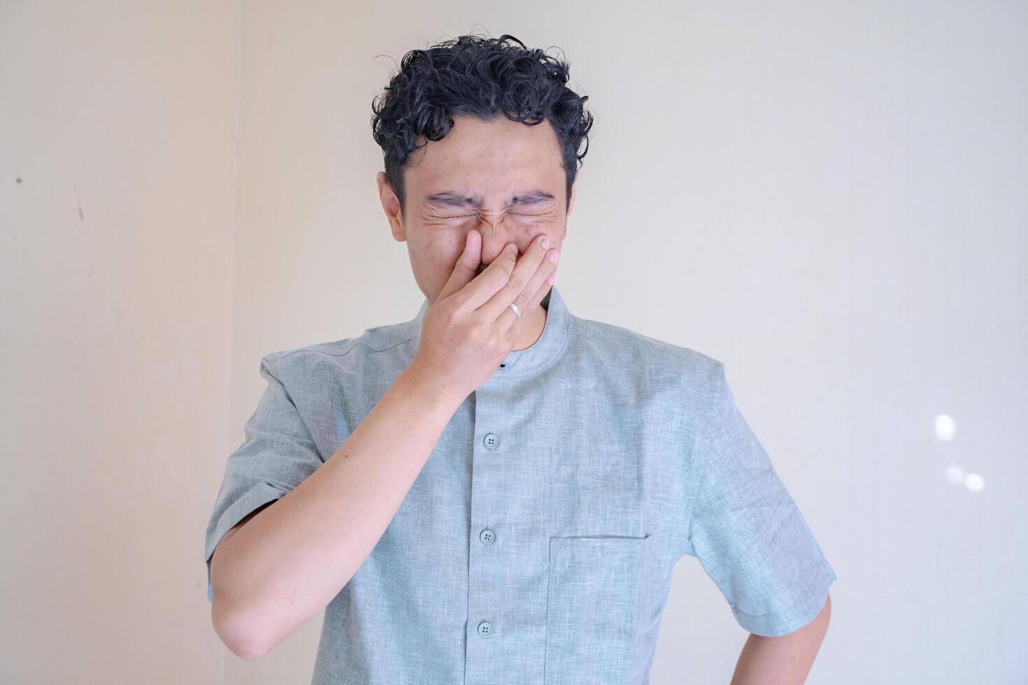 musulmano asiatico uomo odore cattivo su il suo corpo gesto quando Ramadan celebrazione. il foto è adatto per uso per Ramadhan manifesto e musulmano soddisfare media.