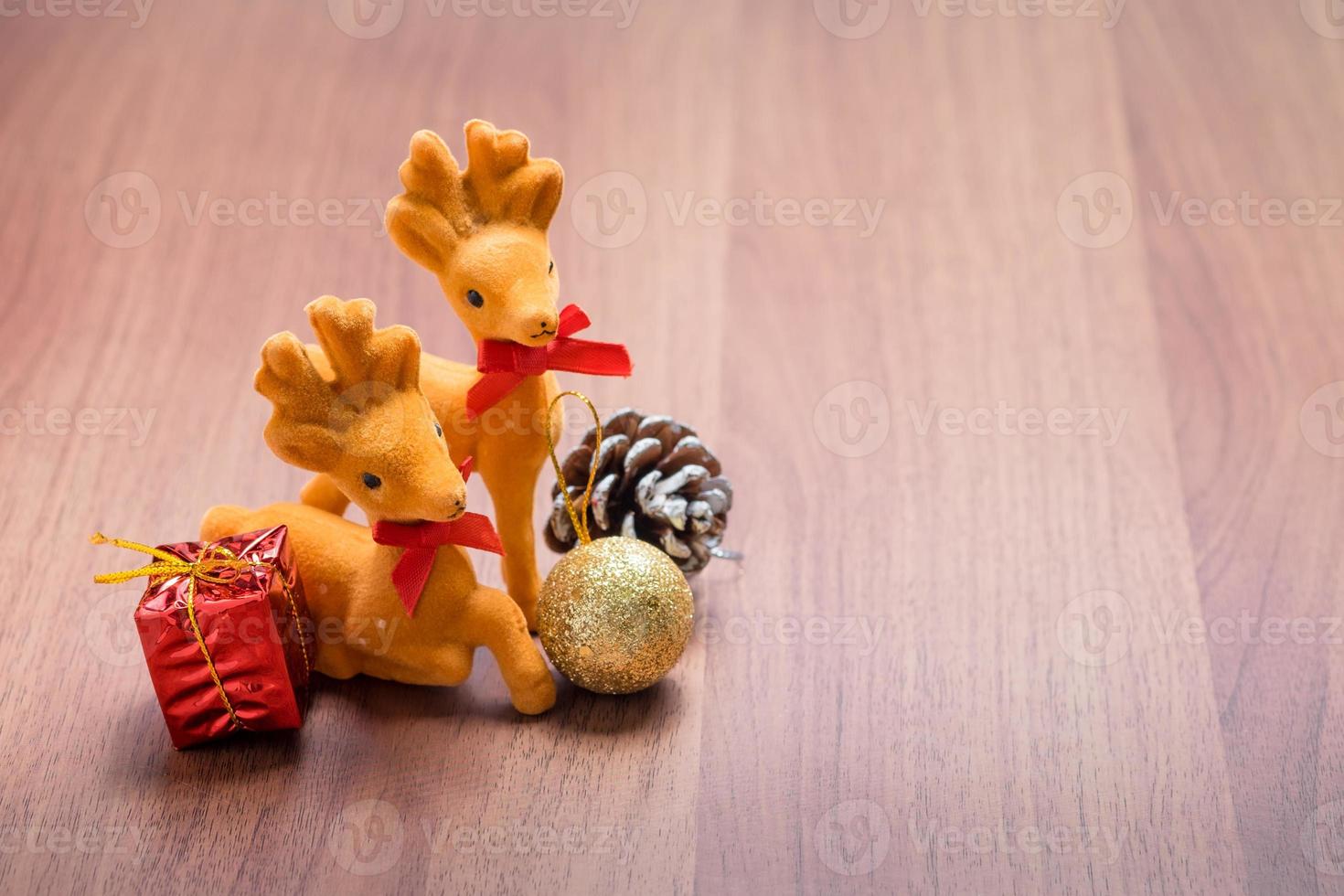 capodanno e decorazione natalizia renne e regalo su tavola di legno marrone foto