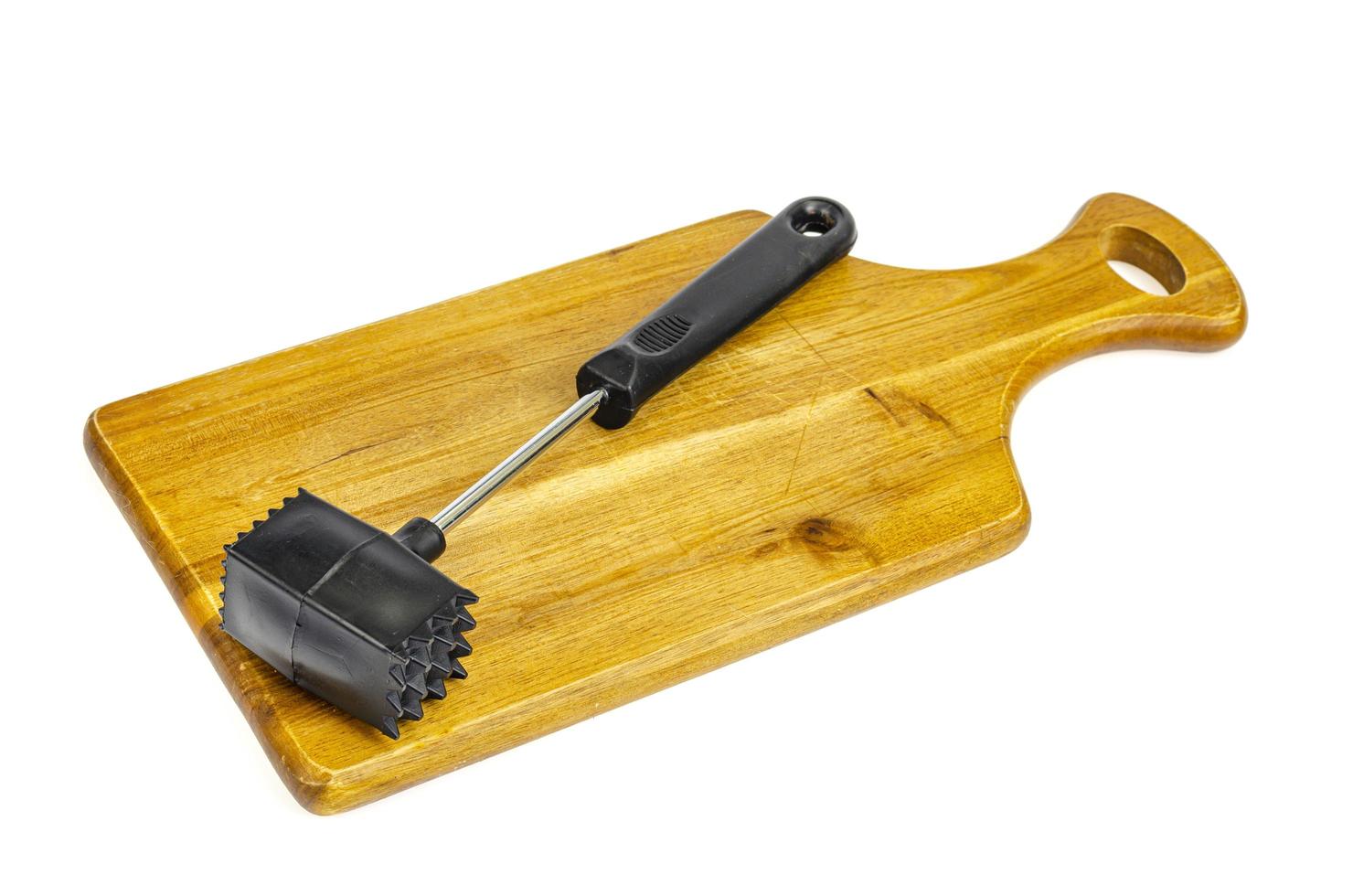 martello da cucina per carne su tagliere di legno. foto