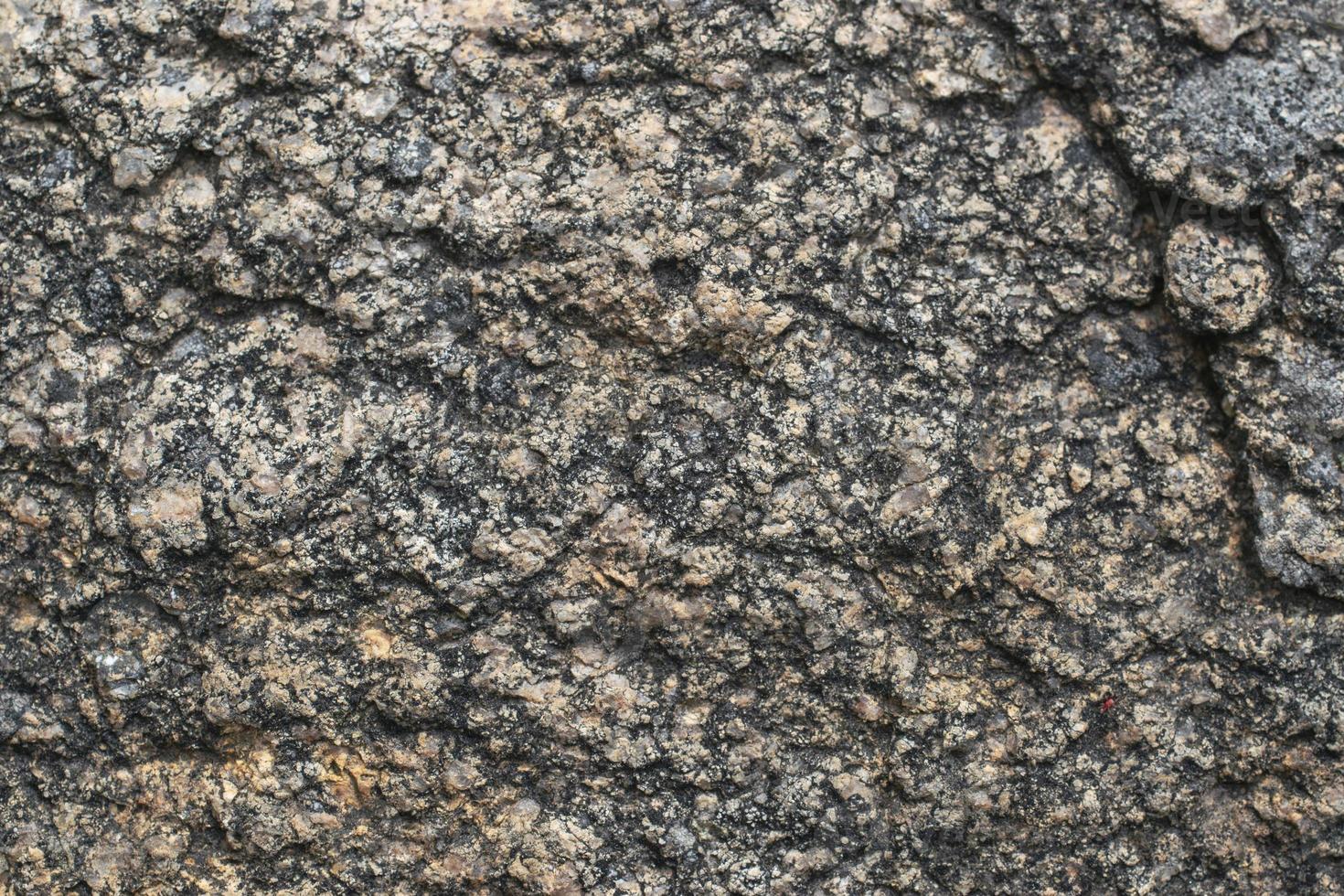 muro di granito in pietra naturale con struttura ruvida foto
