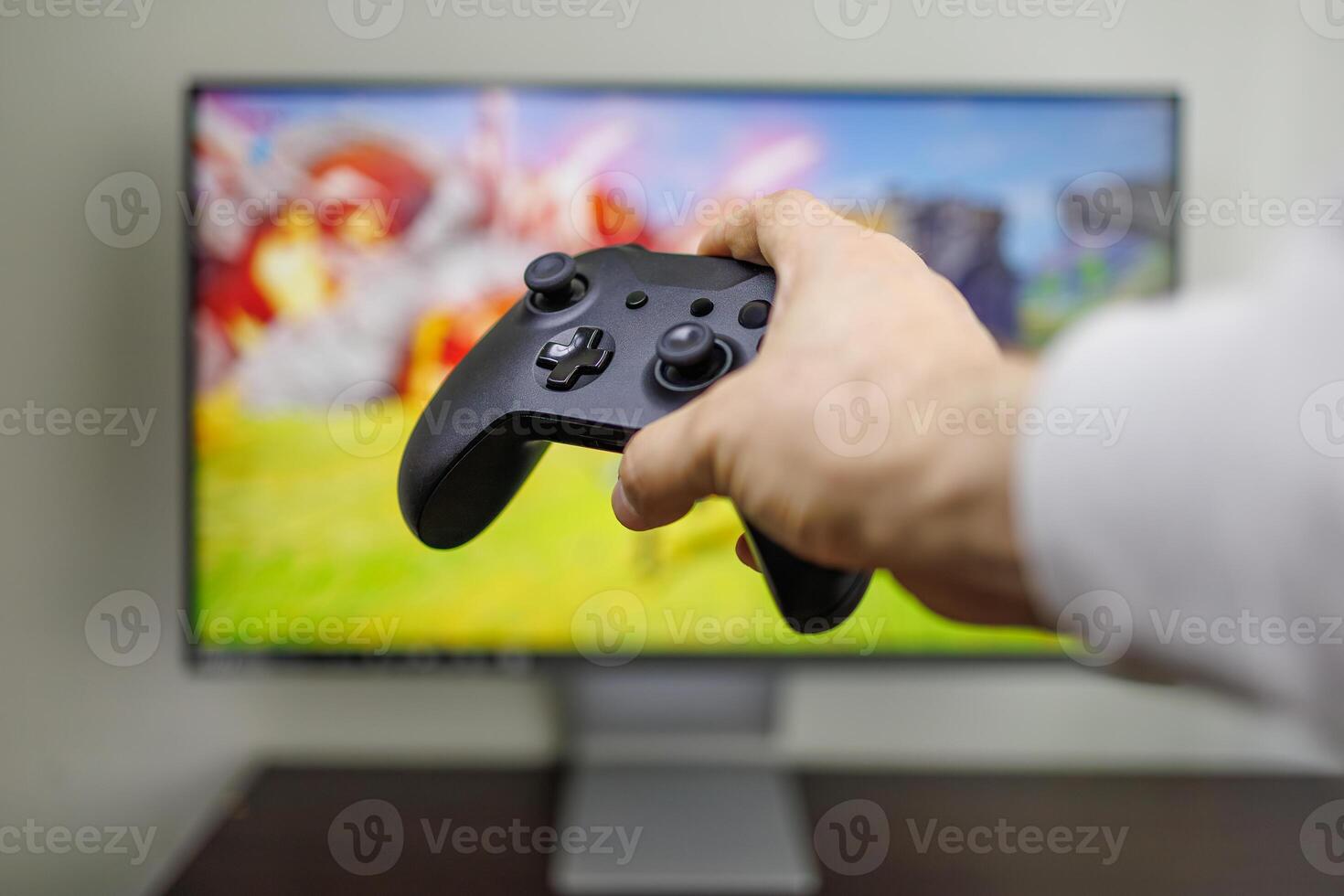 c'è un' gamepad nel il sfondo di il gioco tenere sotto controllo nel il suo mani gioco gamepad nel mano foto