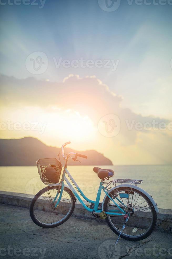 parcheggio per biciclette d'epoca su strada vuota contro la bella luce del sole sopra il cielo foto