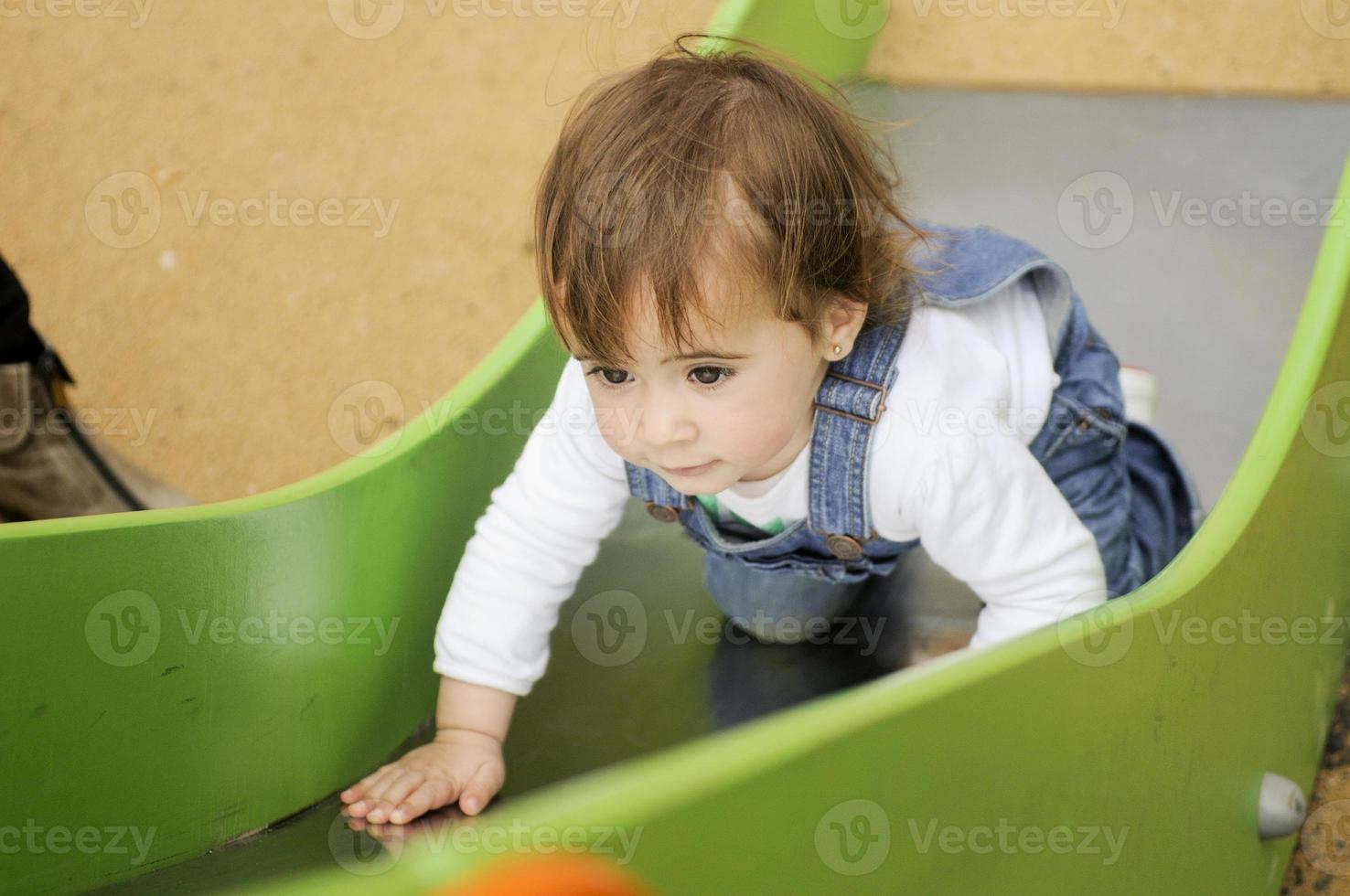 bambina che gioca in un parco giochi urbano. foto