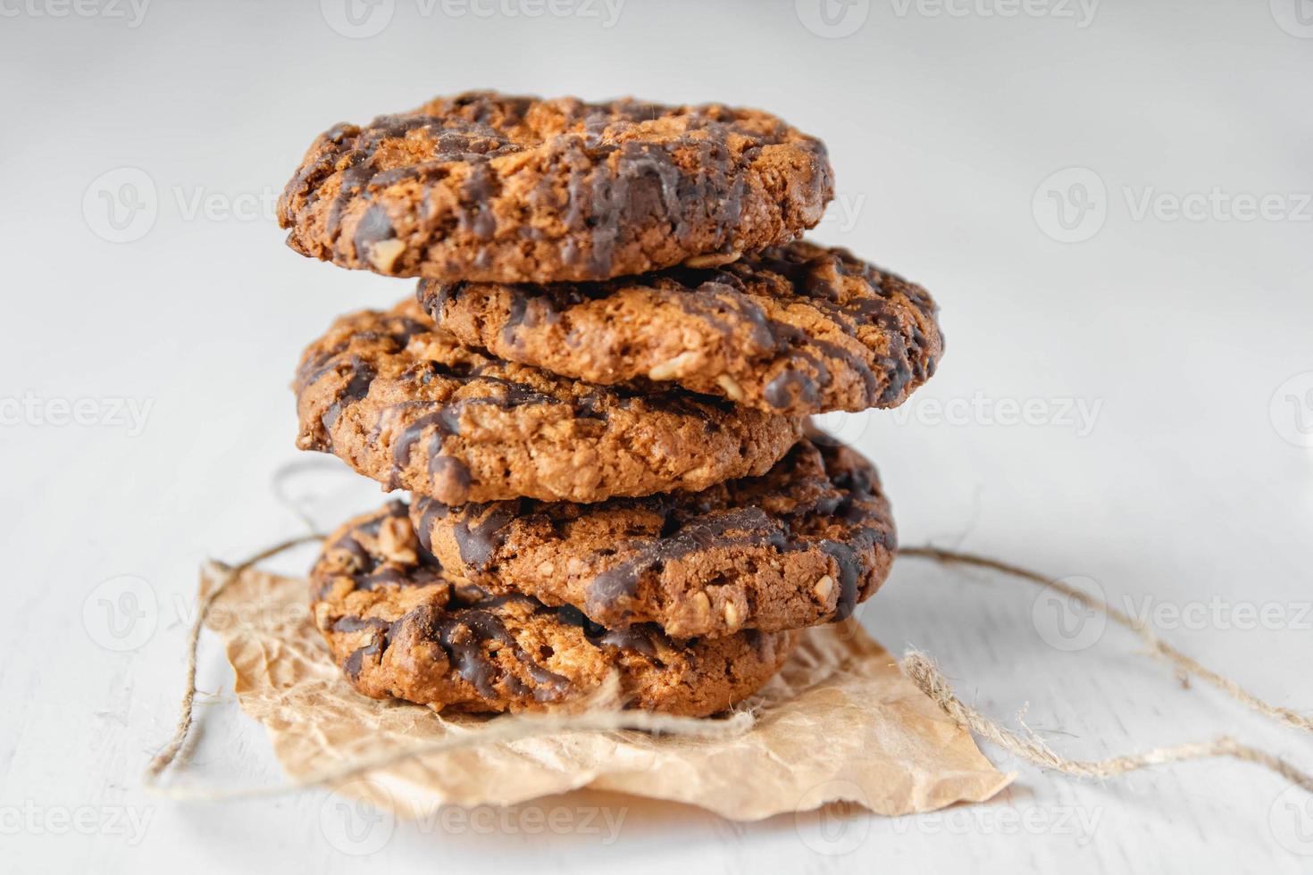 deliziosi biscotti con scaglie di cioccolato su sfondo bianco da tavola foto