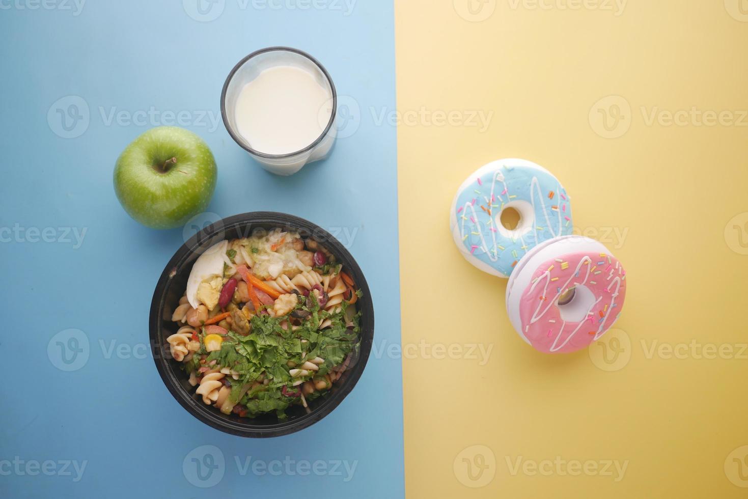 confrontando il concetto di cibo sano e spazzatura sul tavolo foto