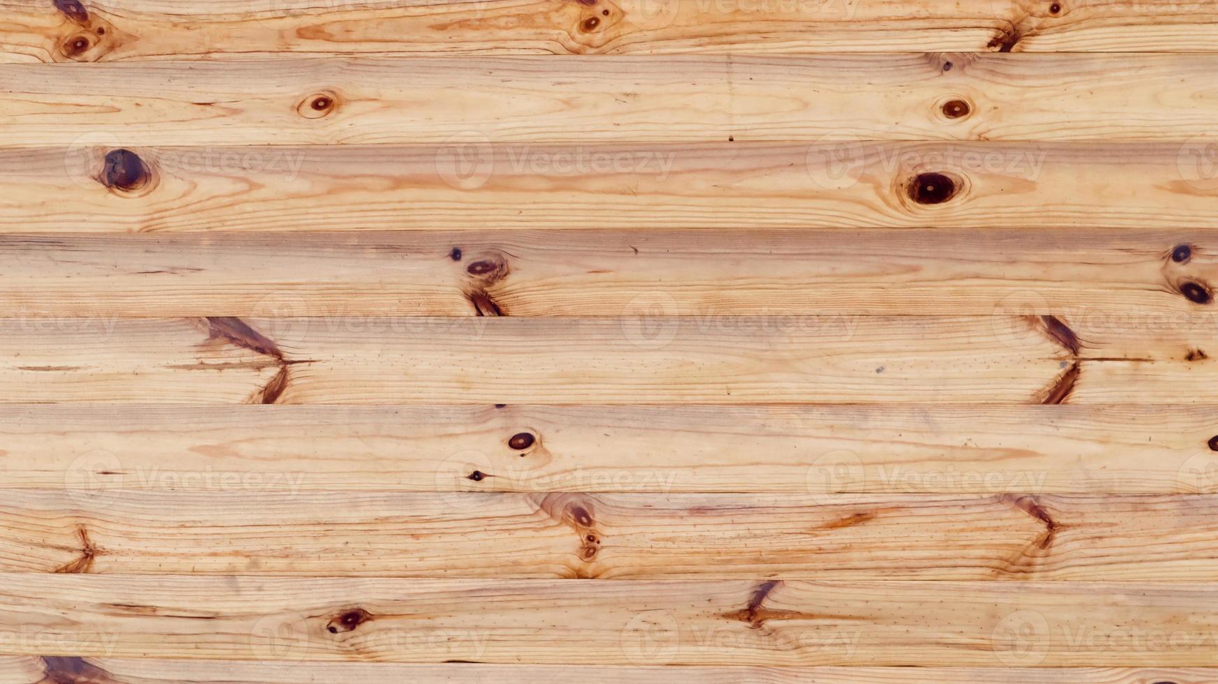 fondo di struttura di legno rustico marrone. motivo di sfondo naturale da un muro di tronchi. facciata di una casa di tronchi, copia dello spazio. una tavola con tanti tronchi di legno orizzontali. foto