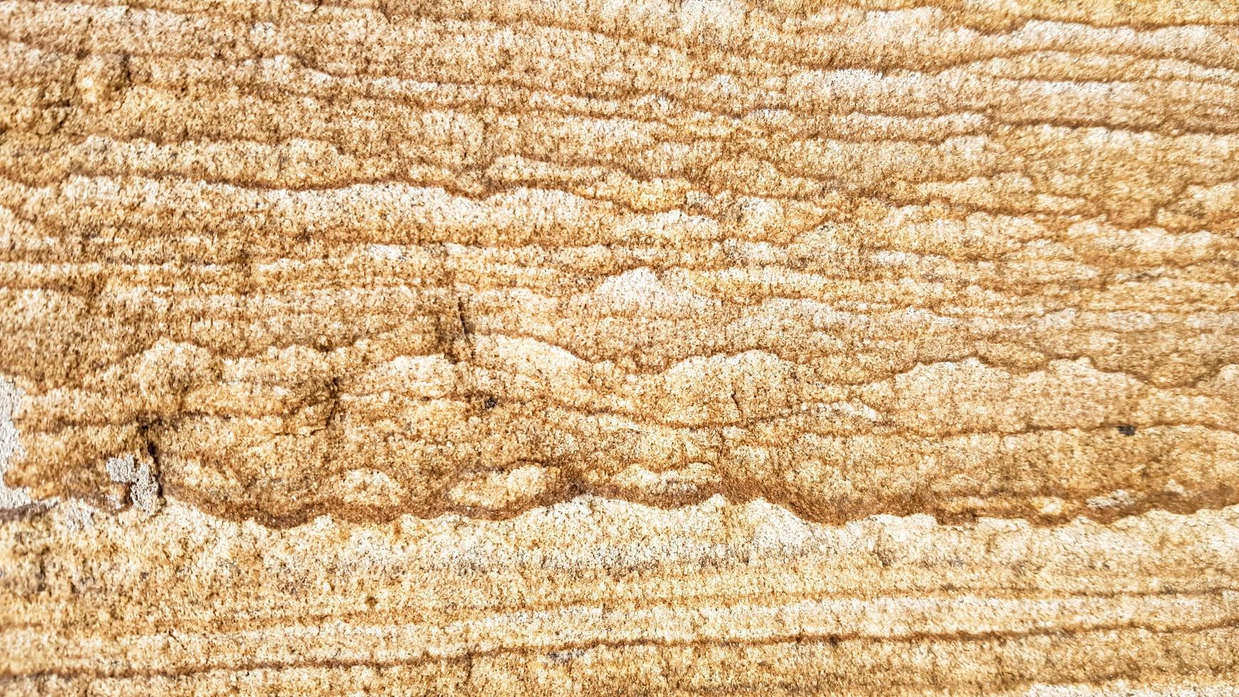 la superficie di arenaria con venature ondulate marroni. struttura dell'agata solforata. ampia immagine di sfalerite texture pietra naturale marrone. bellissimo motivo ondulato di taglio di pietra schalenblende close-up foto