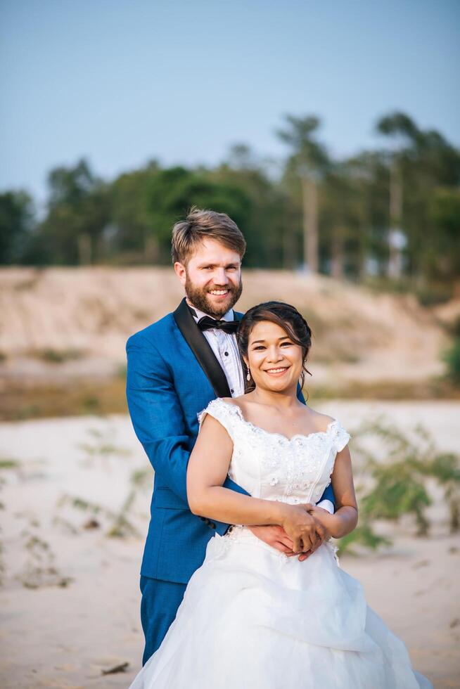 la sposa asiatica e lo sposo caucasico hanno tempo di romanticismo e sono felici insieme foto