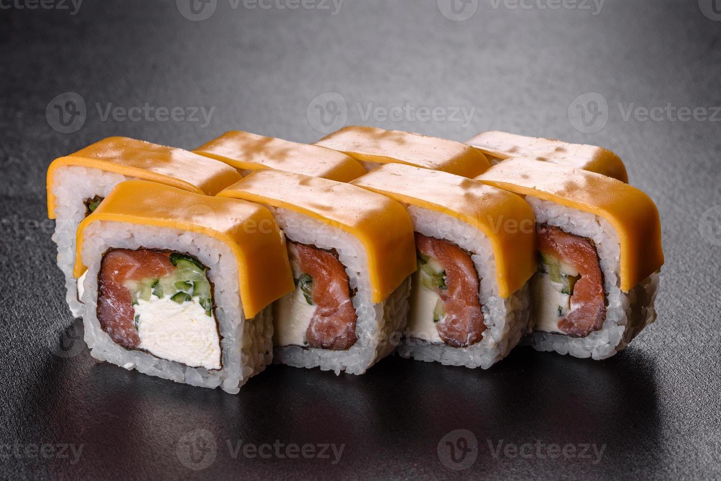 tradizionale delizioso rotolo di sushi fresco impostato su sfondo nero foto