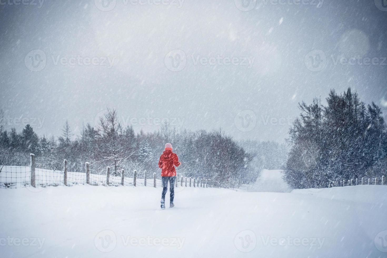 donna che corre da sola con motion blur durante il freddo giorno di neve invernale in canada foto