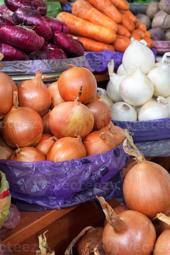 vari tipi di cipolle, gialle, bianche, rosse, sono vendute in vaschetta sul mercato. foto