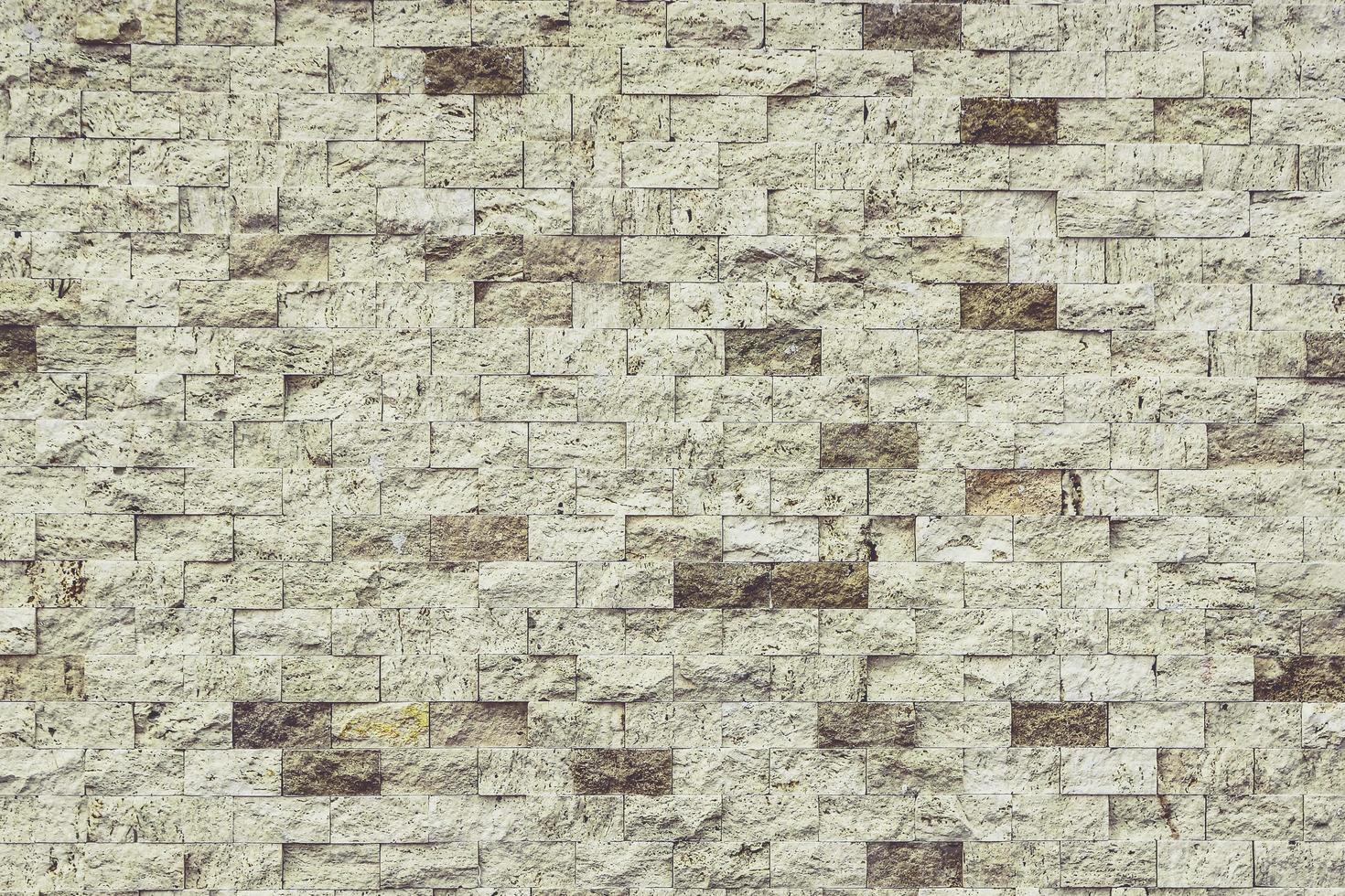 muro di pietra perfettamente organizzato, trama bianca e cioccolato dalla trama di sfondo del muro di roccia foto
