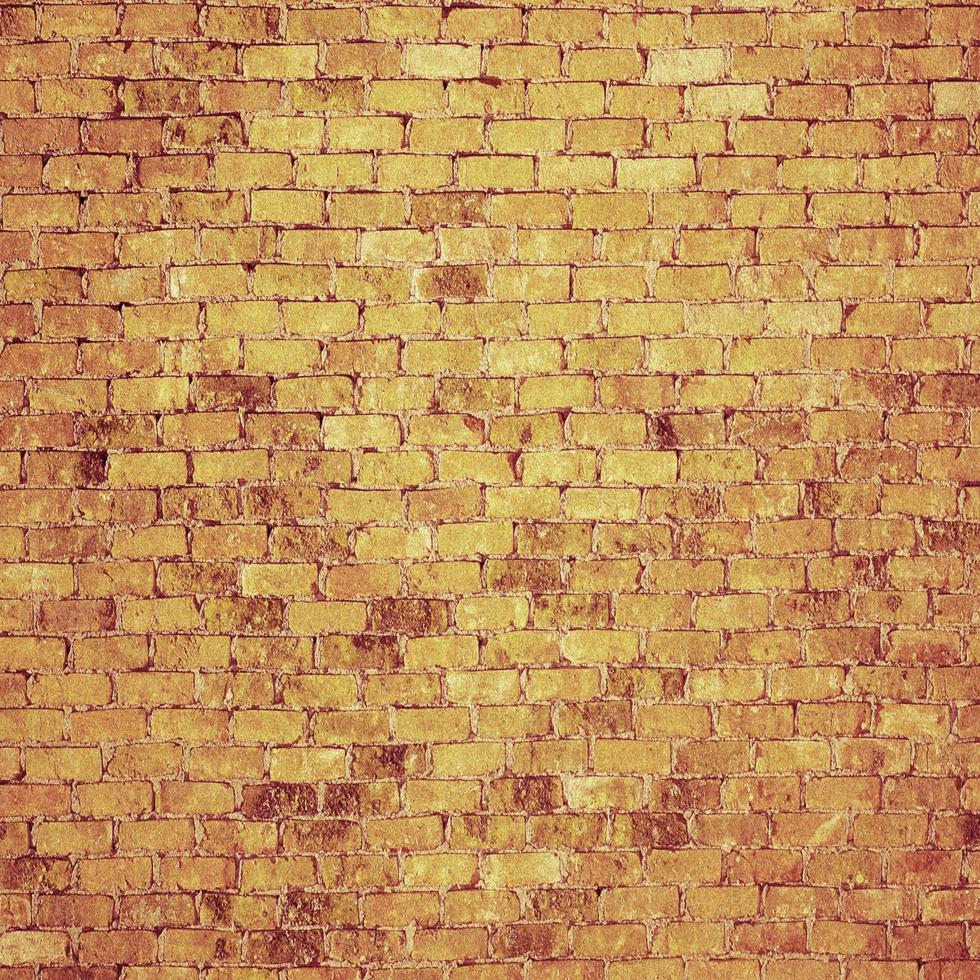 muro di mattoni di colore arancione chiaro astratto sfondo grunge con texture invecchiata in difficoltà e pittura a pennello foto