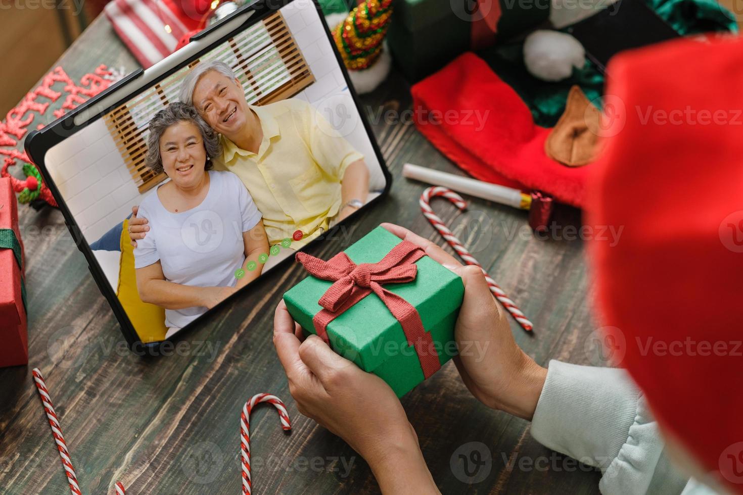 videochiamata di natale e capodanno con la famiglia con tablet insieme a casa foto
