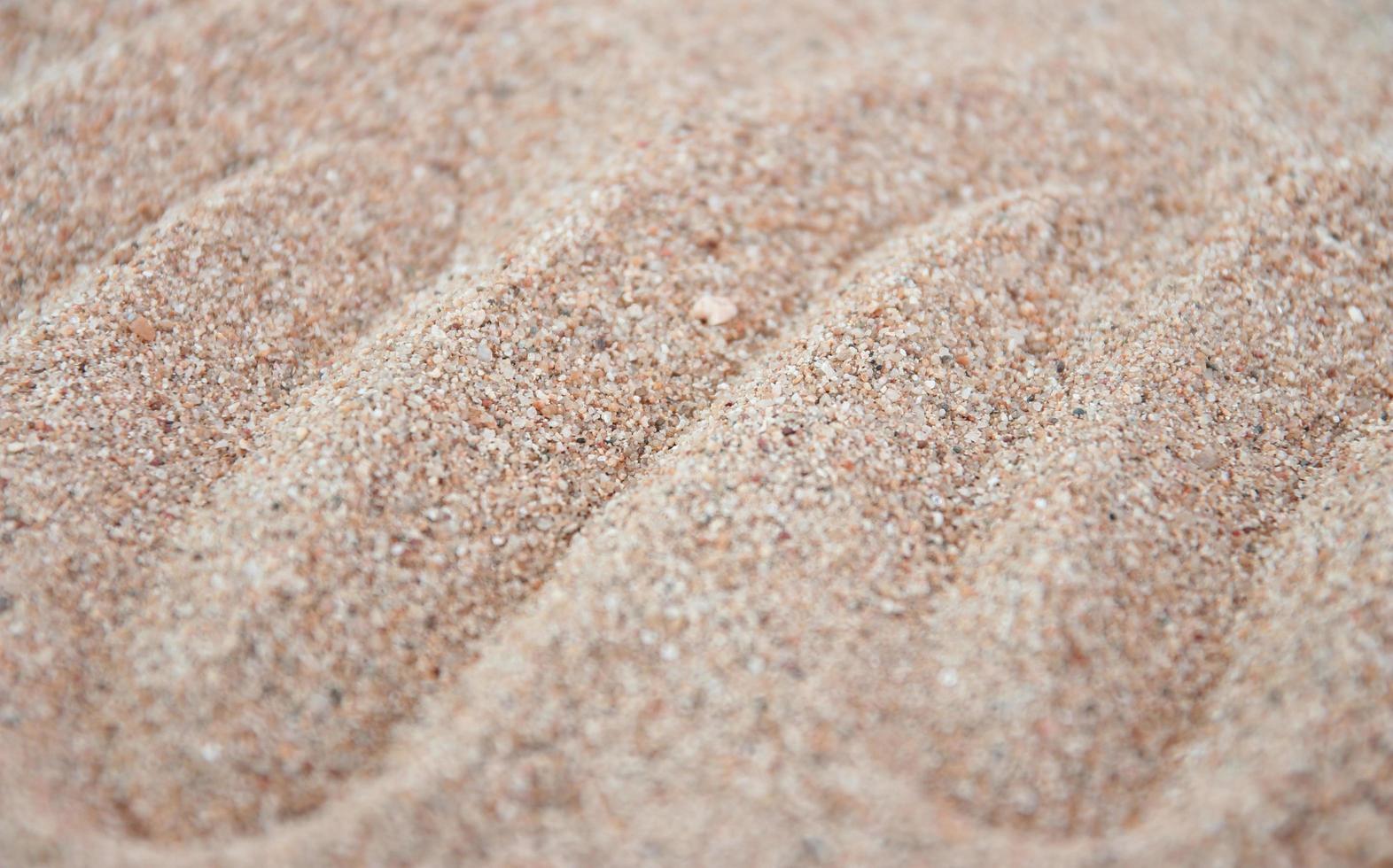 trama di sabbia. spiaggia sabbiosa per lo sfondo foto