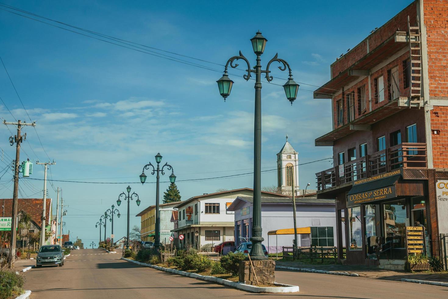 cambara do sul, brasile - 19 luglio 2019. sgargianti pali della luce e case con negozio sul viale getulio vargas a cambara do sul. un piccolo paese rurale con incredibili attrazioni turistiche naturali. foto