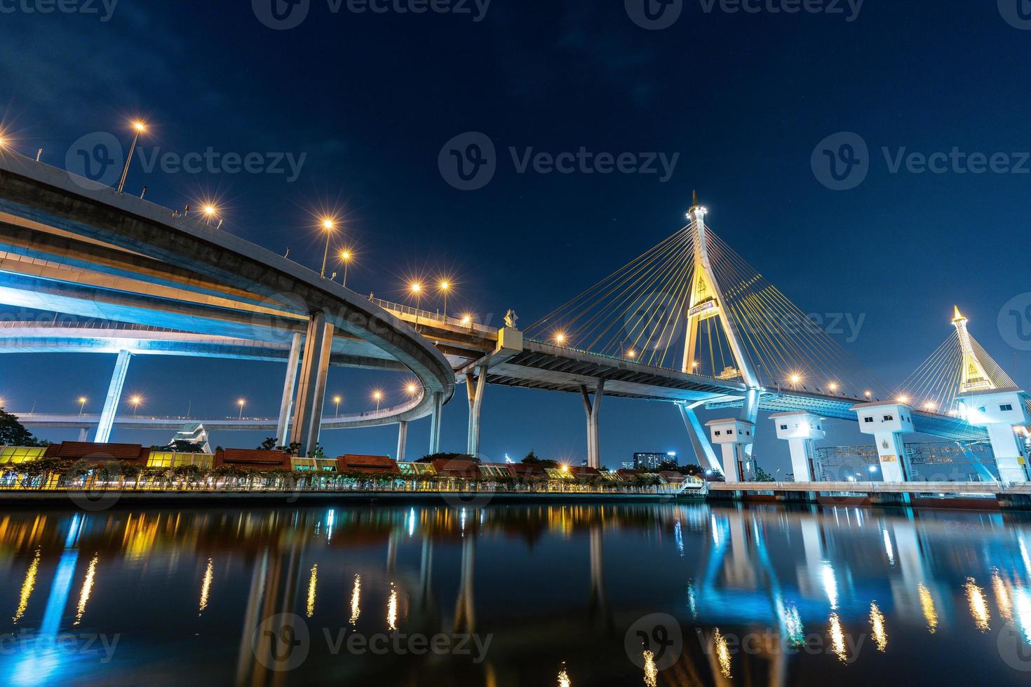 Il ponte sospeso di bhumibol attraversa il fiume chao phraya a bangkok, in thailandia alla sera. è uno dei ponti più belli della thailandia. messa a fuoco selettiva. foto