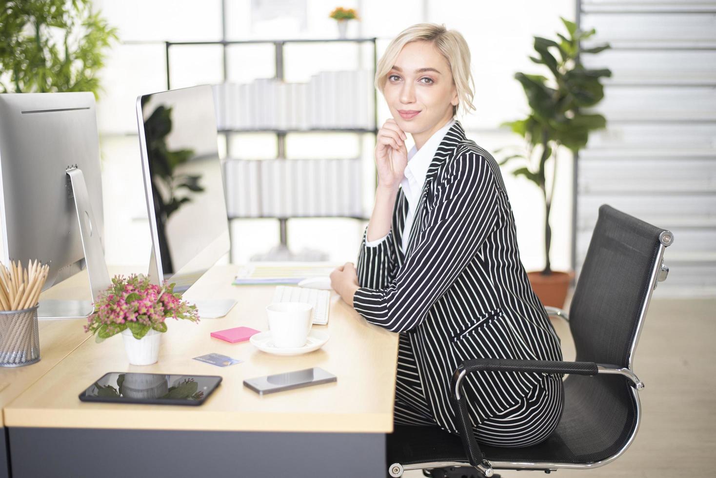 bella donna d'affari caucasica intelligente in ufficio foto