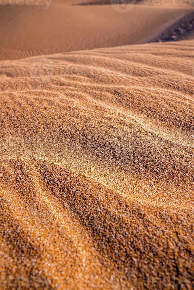 bella sabbia marrone lucida con motivo a onde naturali in una giornata di sole foto