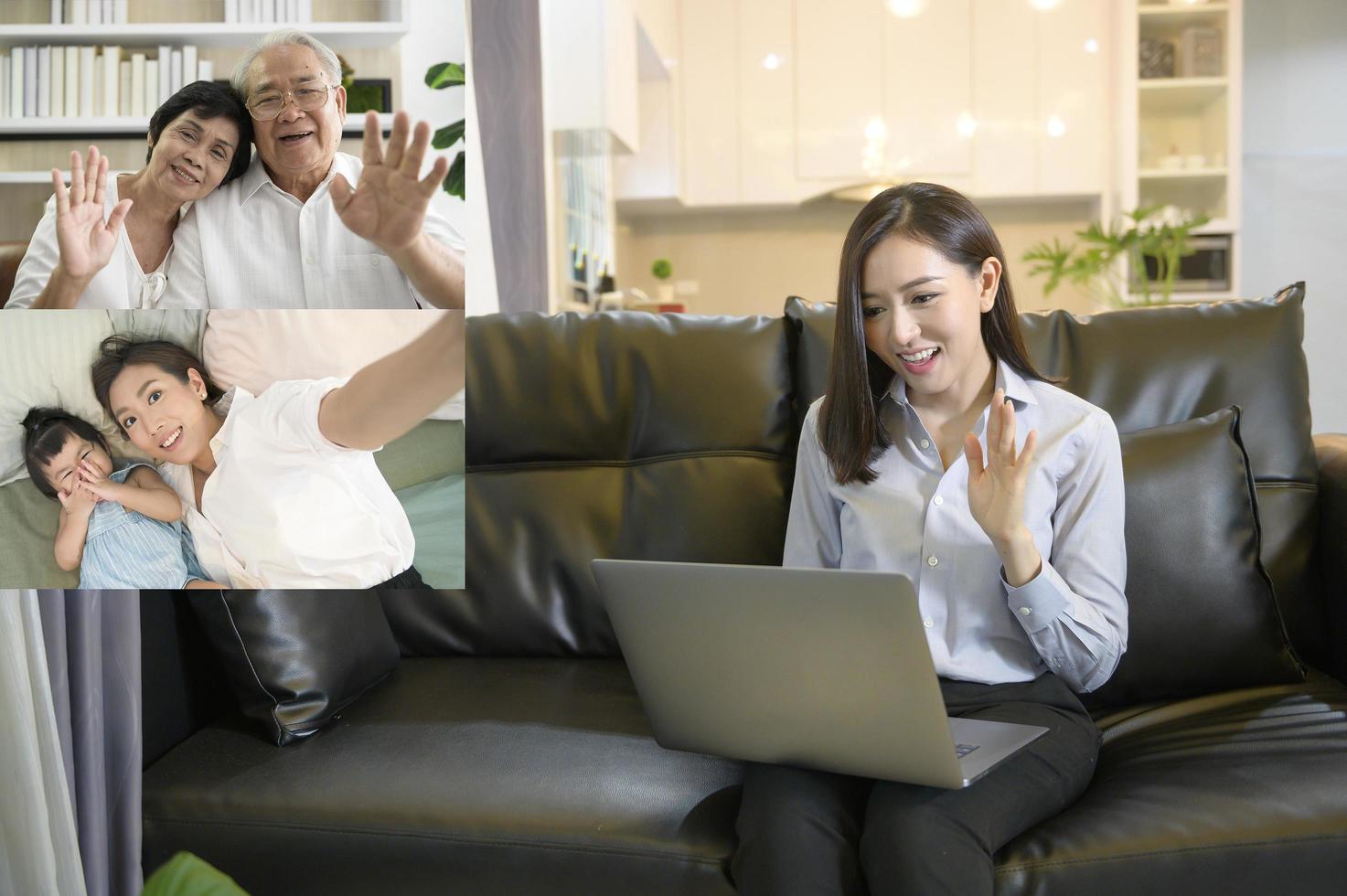 una giovane donna asiatica sta usando un computer portatile per videochiamare o una webcam per salutare la sua famiglia, la tecnologia delle telecomunicazioni, il concetto di famiglia genitoriale foto