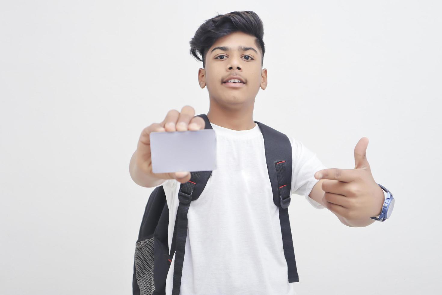 studente di college indiano che mostra carta su sfondo bianco. foto