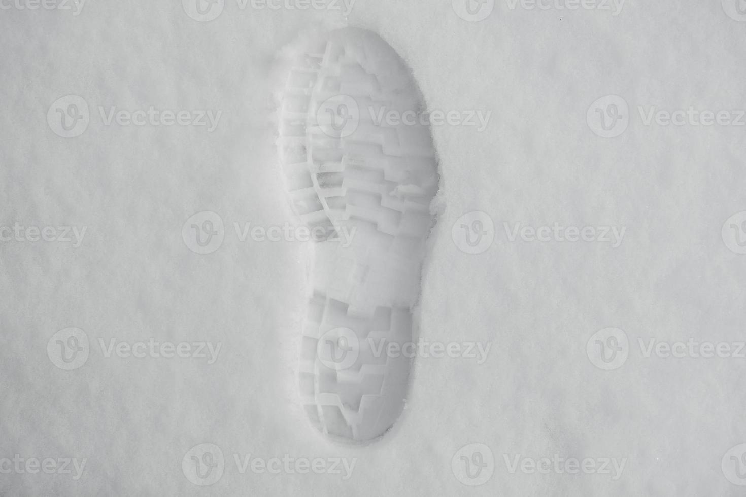 impronta di una scarpa nella neve. un'unica impronta chiaramente definita di una scarpa o uno stivale sulla neve foto