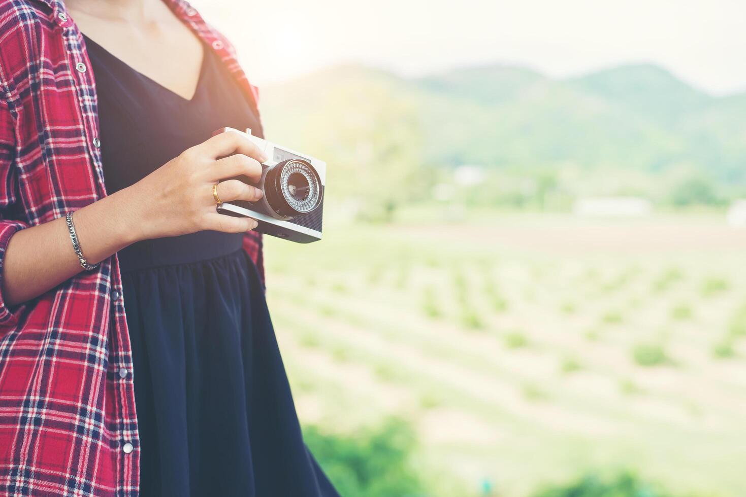 fotografo di giovane donna hipster in possesso di una macchina fotografica d'epoca. foto