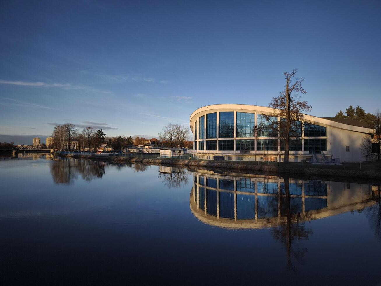 ceske Budejovice, ceco repubblica, 2024 - nuoto piscina e sauna moderno edificio riflettendo su calma vltava fiume foto