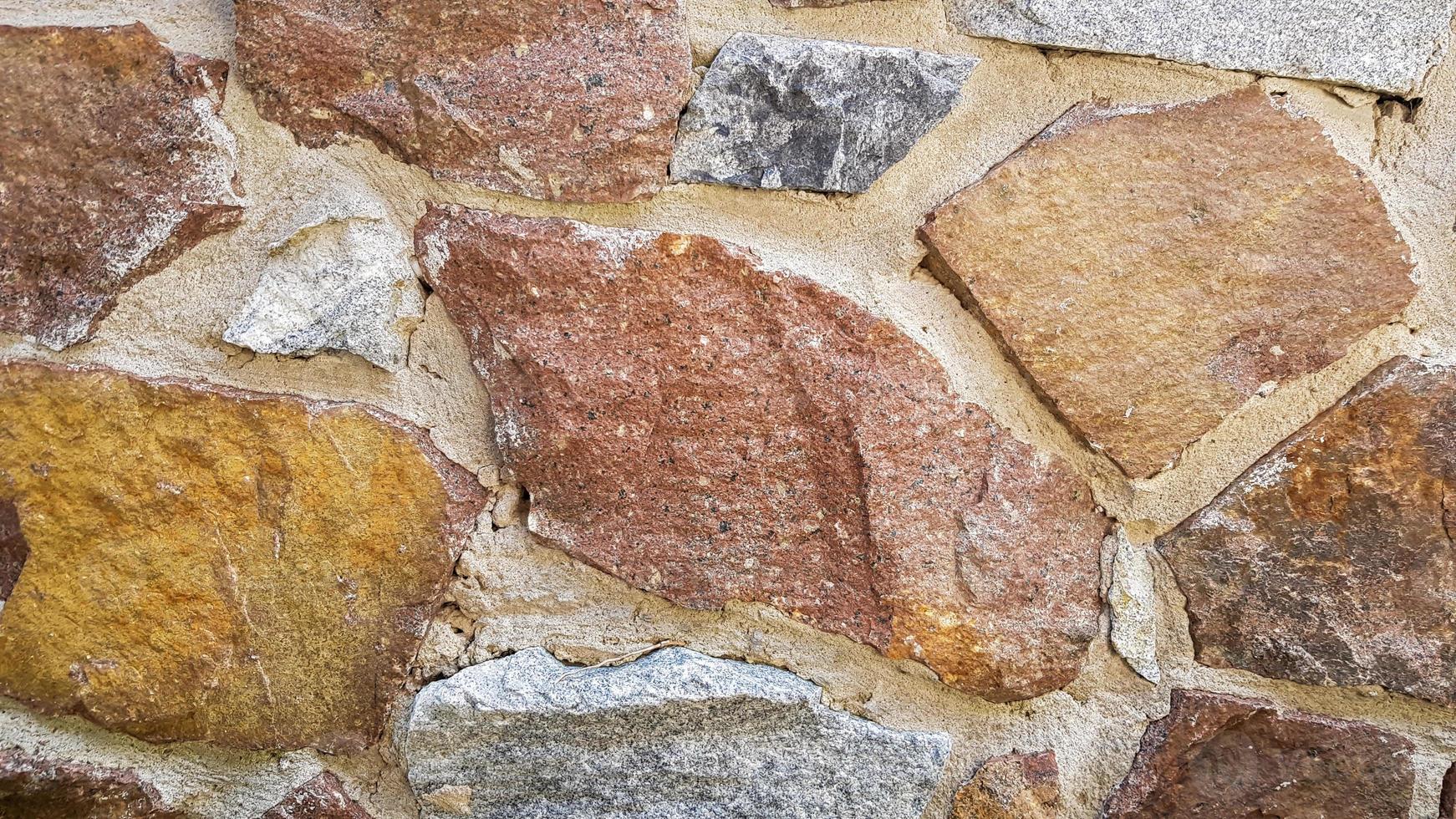 sfondo grigio muro di pietra. la consistenza della pietra. vecchio fondo del muro del castello. muro di pietra come sfondo o texture. parte del muro, per lo sfondo o la trama. foto