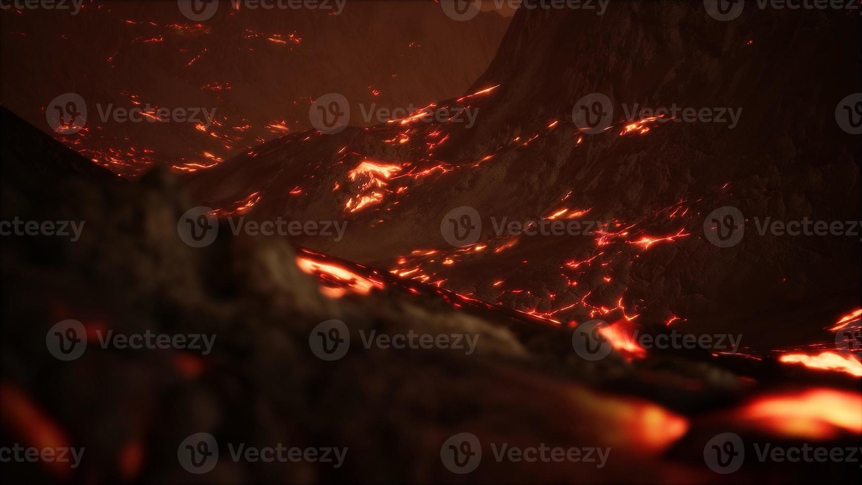 lava fusa rossa e arancione vibrante che scorre su un campo di lava grigio e su una terra rocciosa lucida foto