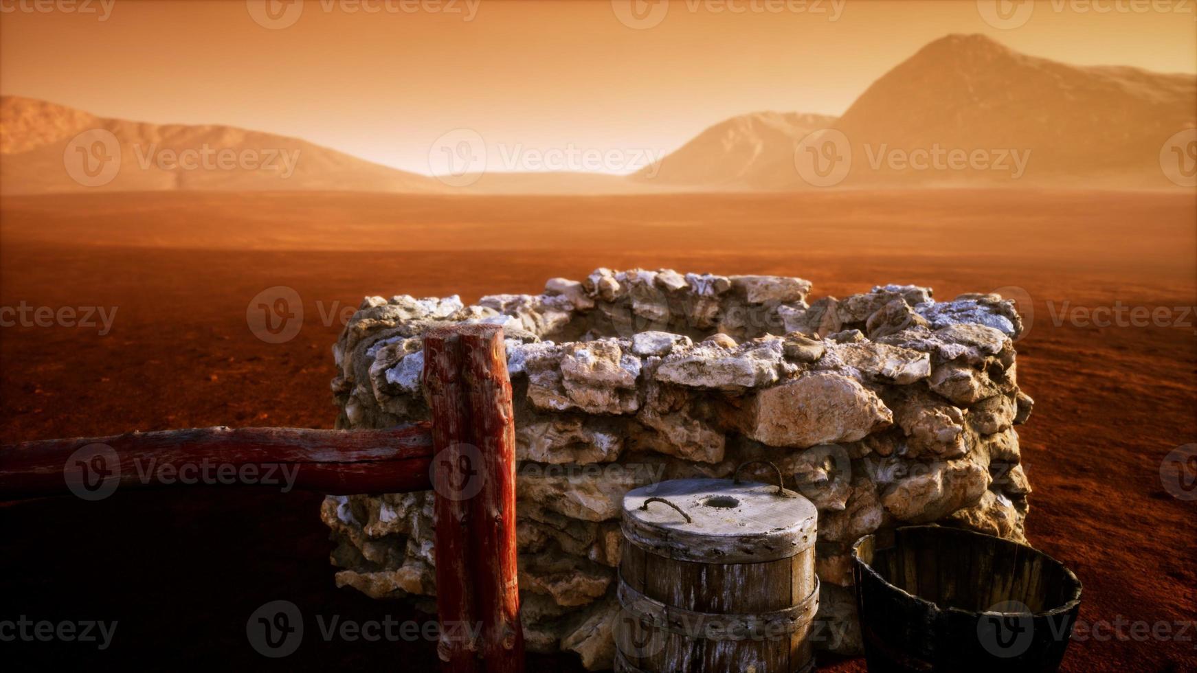 vecchio pozzo d'acqua di pietra nel deserto foto