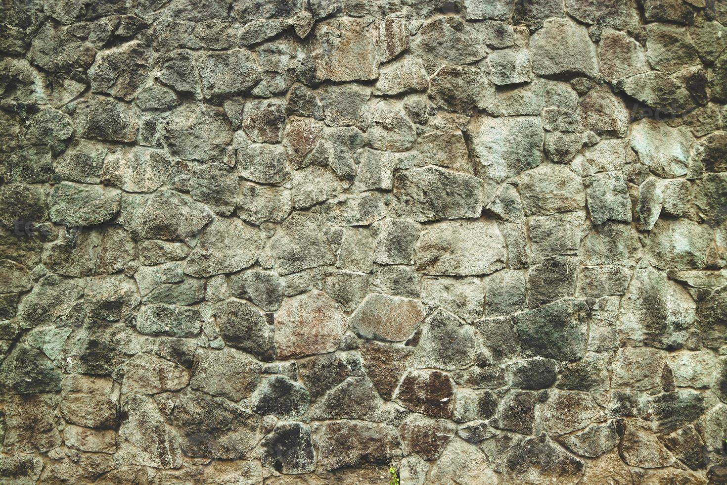 fondo tradizionale astratto di struttura della pavimentazione della parete di pietra. muro di pietra strutturato irregolare realizzato in lastre di pietra e lastricato. foto