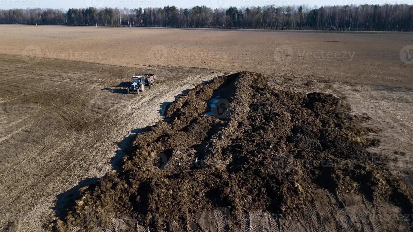 mucchio di letame sul campo. lavoro nei campi primaverili. rilievo aereo foto