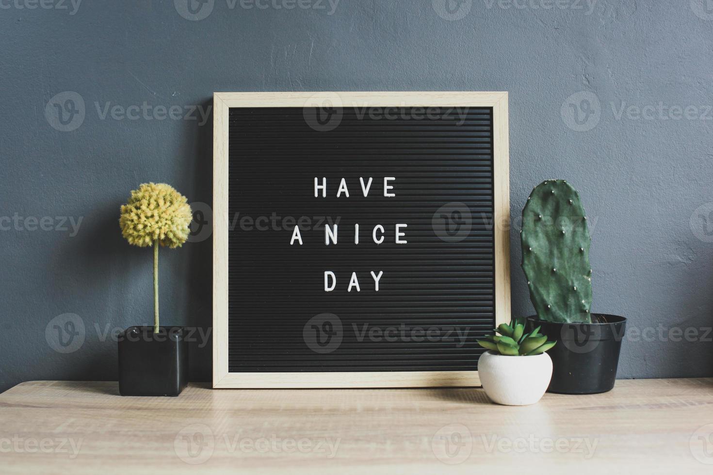 buona giornata citazione sulla lavagna con cactus, piante succulente e decorative su tavola di legno foto